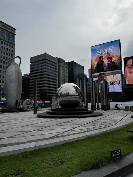 stock image Seoul, South Korea - 10 Aug 2024: Banner on buildings near COEX Mall with Metal steel big ball at the centre 