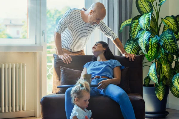 Family Living Room Dad Looks Fondly Mom Who Tired Because — Stock Photo, Image