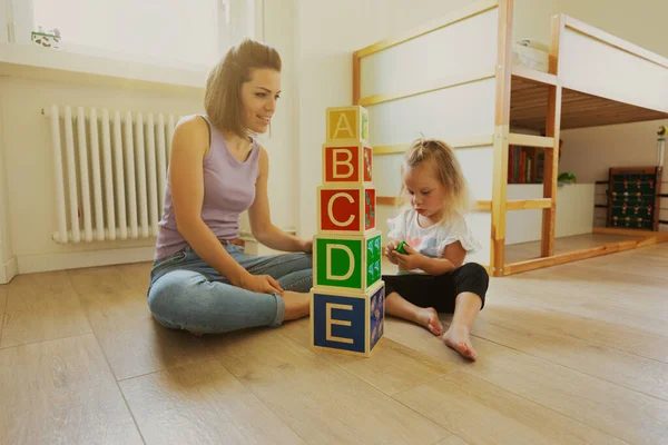 Mother Daughter Play Wooden Cubes Letters Faces Able Hold Smaller — Stockfoto