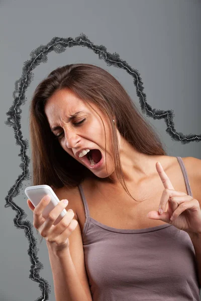 angry woman turns her anger by shouting at a mobile phone accompanying with a hand gesture and raised index finger. Additional emphasis augmented by graphic effect. The young woman has a large mouth a