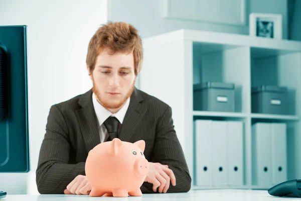 Concept Savings Expenses Business Young Man Suit Looks Dejectedly Piggy — Stock Photo, Image