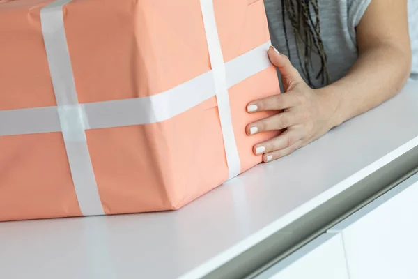 Woman Hand Embraces Large Orange Gift Box White Ribbon White — Stock Photo, Image