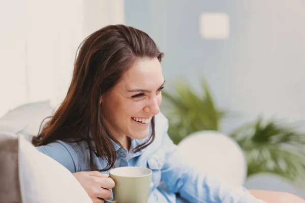 Happy Smiling Woman Sits Her White Couch Home Enjoying Her — Stock Photo, Image