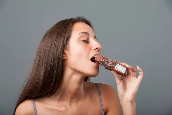 Oung Woman Voluptuously Bites Chocolate Hazelnut Covered Ice Cream Cookie — Stock Photo, Image