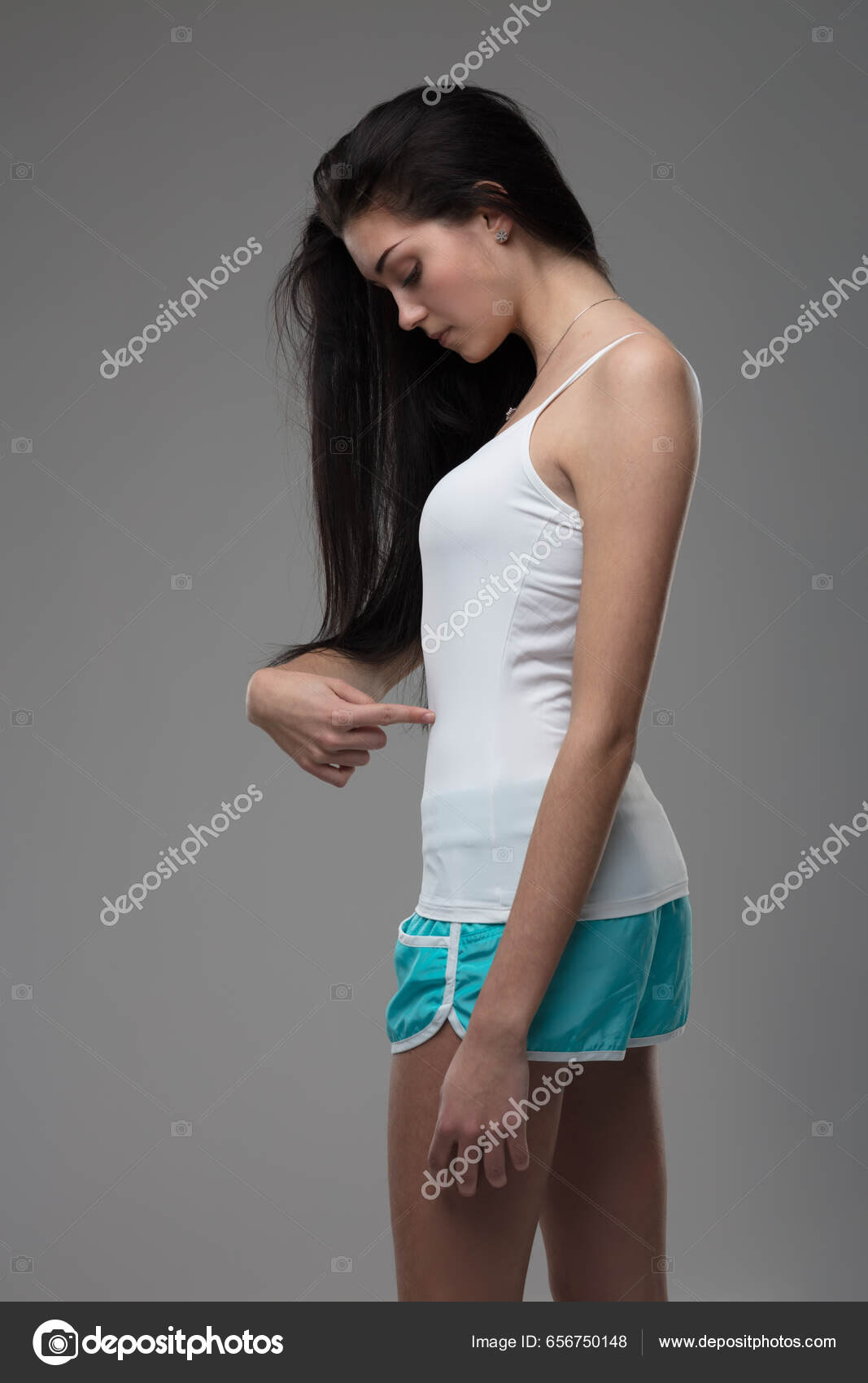 Portrait of young attractive woman wearing tank top and shorts