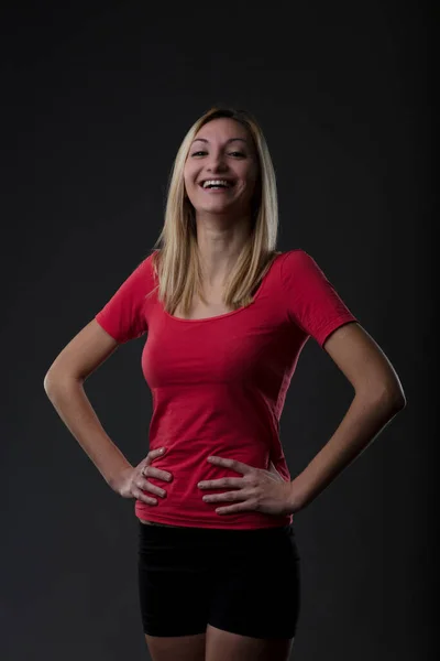 Blonde Woman Laughing Hands Hips Portrait Gym Attire Red Shirt — Stock Photo, Image