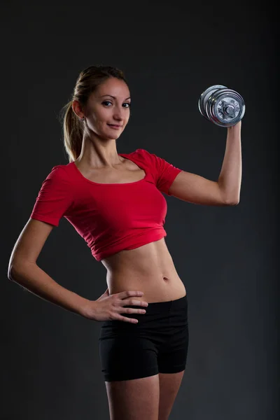 Blonde Girl Lifting Weights Gym Showcasing Her Flat Stomach Wearing — Stock Photo, Image
