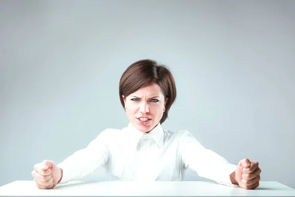 Frustrated Woman Short Hair White Shirt Slams Fists Sterile Desk — Stock Photo, Image
