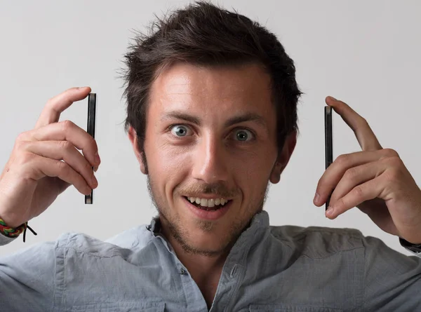 Ridiculous Symbolic Image Young Man Two Smartphones Too Busy Calls — Stock Photo, Image