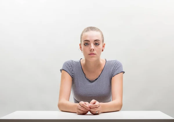 Young Woman Impassive Yet Stern Striped Tee Tied Hair Places — Stock Photo, Image