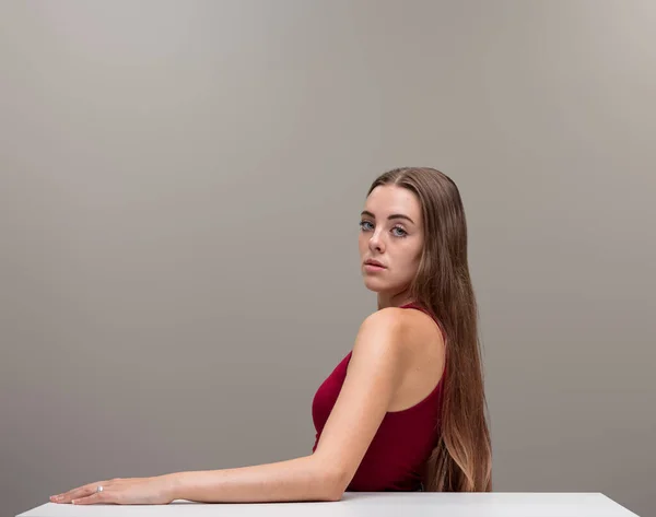 Stunning Girl Long Hair Sitting White Desk Turns Glance Conscious — Stock Photo, Image