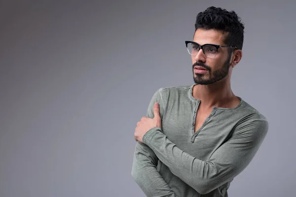 Cool guy in a green long-sleeved shirt, black glasses, and short black hair. Fit, sexy, desirable, handsome, and a semiotics genius. Also bionic