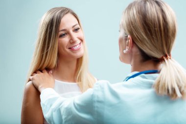 A blonde doctor deeply cares for her patient. Beyond physical health, she values human connection, trust and emotional well-being clipart