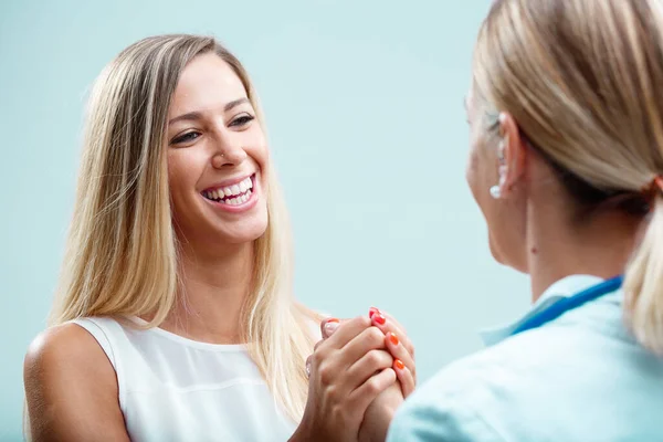 stock image Blonde physician with her patient, caring for her physically and emotionally. Their relationship built on trust and true concern