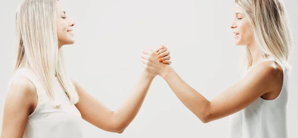 Two Blonde Women Sharing Secret Handshake Reinforcing Bond Joy Camaraderie — Stock Photo, Image