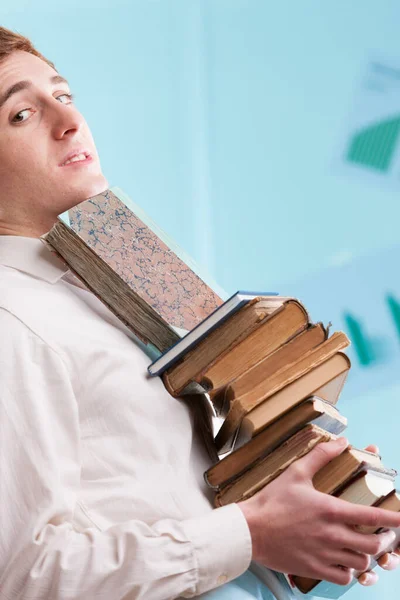 Stack Ancient Looking Books Held Young Man Diagonally Blurred Background — Stock Photo, Image