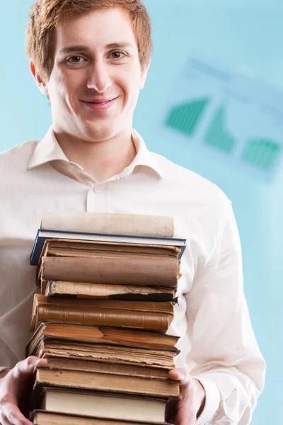 Young Man Offers Pile Antique Books Blurred Business Backdrop Knowledge — Stock Photo, Image