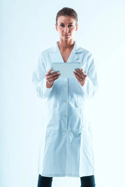 Determined Woman White Coat Holds White Tablet Stem Professional She — Stock Photo, Image