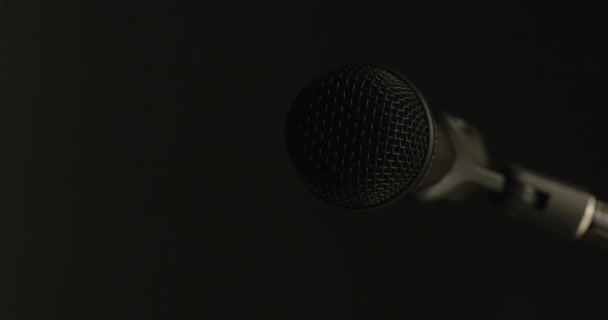 Egy Mikrofon Fokozatosan Kivilágítva Koromfeketéből Majd Elegánsan Visszahúzódik Homályba Egy — Stock videók