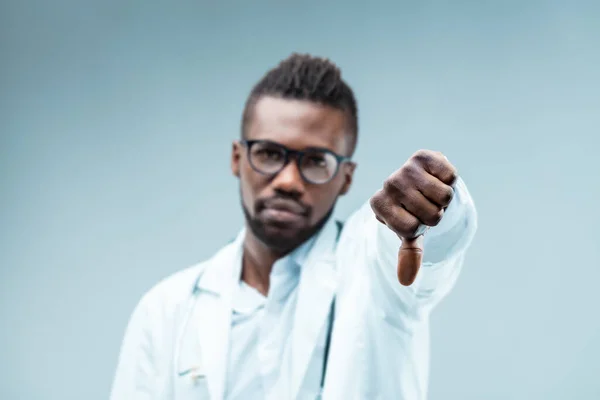 Close Black Male Doctor Thumb Blurred Background Disapproving Unscientific Choices — Stock Photo, Image