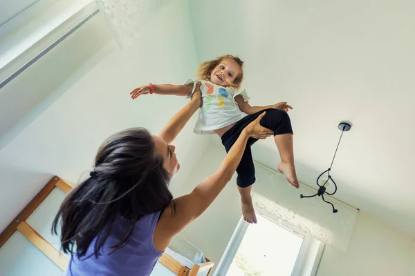Mom Playfully Makes Daughter Fly Room Hands Feet Climbing Flying — Stock Photo, Image