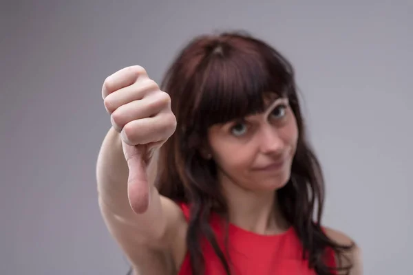 Blurred Adult Woman Background Shows Thumbs Sharp Focus Expressing Disapproval — Stock Photo, Image