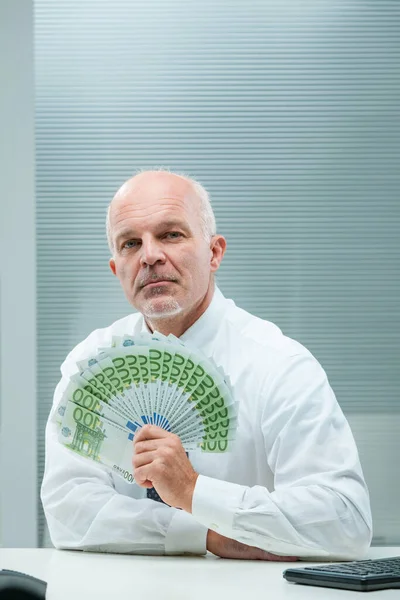 Businessman Leans His Desk Displaying Green European Notes Reflects Power — Stock Photo, Image