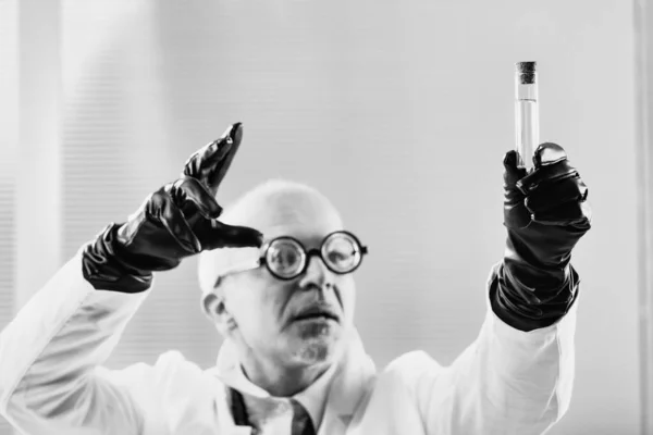 実験室のコートのマスターマインドは 20世紀初頭の黒と白の設定で禁止物質を考案し 政府との隠された同盟または欺瞞を示唆しています — ストック写真