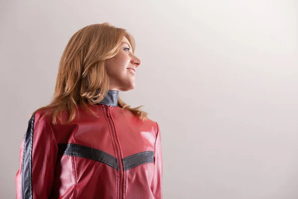 Woman Striking Red Black Motorcycle Jacket Leans Back Curiously Looking — Stock Photo, Image