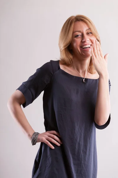 Blonde Woman Gray Blue Dress Makes Playful Gesture Hide Her — Stock Photo, Image