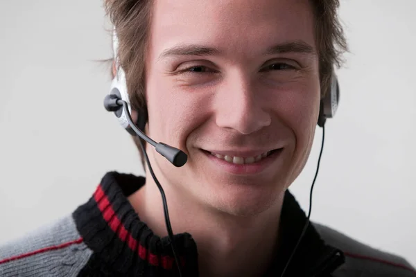 When you reach out to our company, expect a professional like this young man in a black and gray sweater, offering competent and patient assistance via his headset