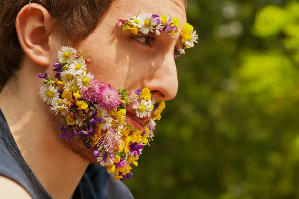 Amidst green, a redhead\'s unique feature: a face blooming with flowers. This deep connection, real or perceived, embodies his profound respect for nature\'s beauty and balance