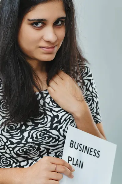 Determined Gaze Dark Haired Woman Clutches Business Plan Intricate Rose — Stock Photo, Image