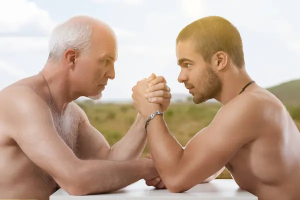 Intense Arm Wrestling Match Elder Younger Bare Chested Men — Stock Photo, Image