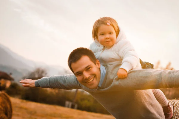 simple joys of childhood are alive in this playful scene of a daughter and her father enjoying an outdoor adventure