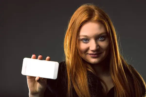 tech-savvy woman presents a smartphone, symbolizing connectivity and modern communication