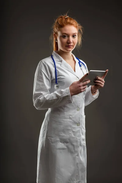 Confident Female Doctor Striking Hair Color Uses Tablet Symbolizing Intersection — Stock Photo, Image