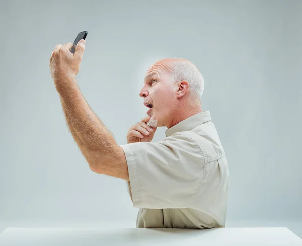 The man\'s animated gesture with his phone captures the essence of a tender digital interaction