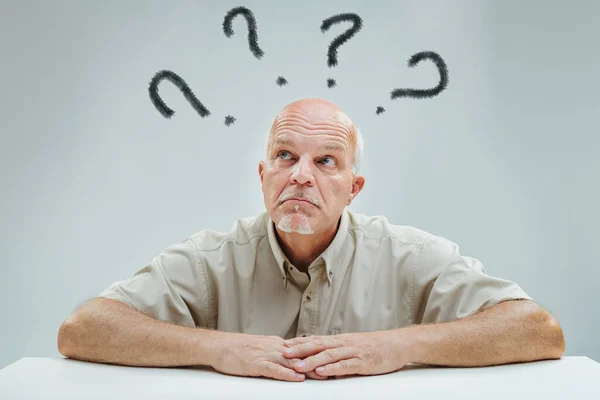 elder\'s puzzled look, with question marks aloft, signals his contemplation of unanswered questions