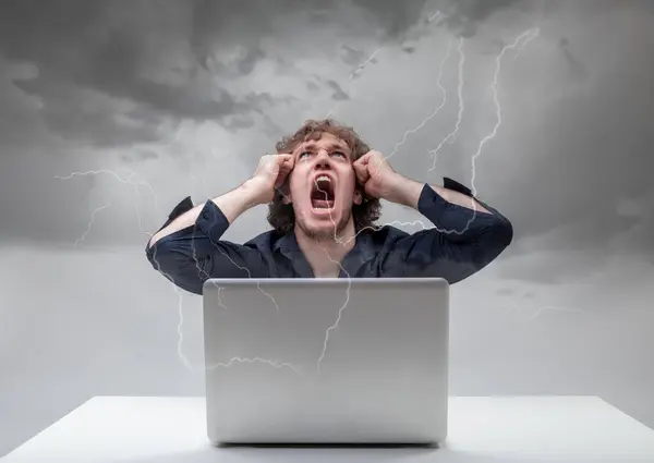 男人在笔记本电脑上的尖叫声和令人毛骨悚然的动作显示出最大的挫败感 线条反映出他的混乱 — 图库照片