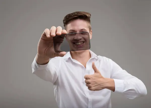 Visionary Young Individual Holds Transparent Smartphone Reflecting Blend Innovation Sleek — Stock Photo, Image