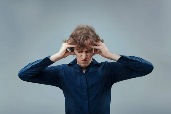 Stressed Man Curly Hair Grips Head Visible Frustration Eyes Shut — Stock Photo, Image