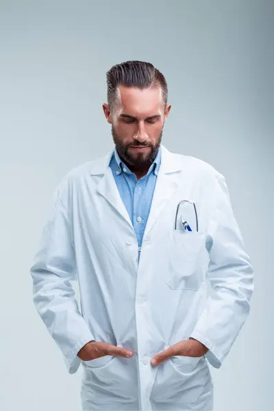 Concerned Medical Professional Contemplates Serious Issue Hands Hips Gaze Lowered — Stock Photo, Image