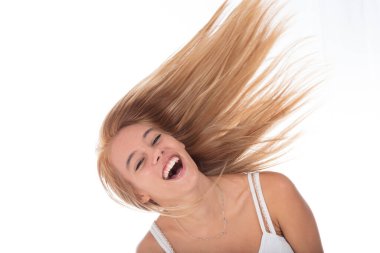 Joyful young woman laughing, her hair dynamically swept in the air, spirited expression clipart