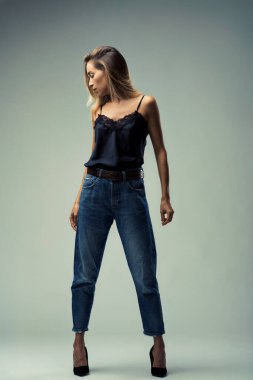 Full body portrait of a young woman, combining casual denim with the delicate femininity of a lacy black top clipart