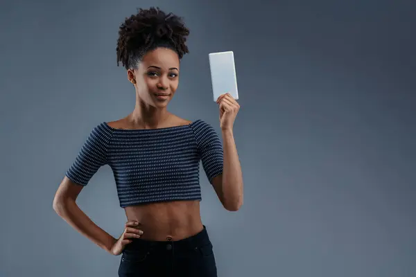 stock image Tech-savvy female recommends app solutions, smartphone in hand, looking assured