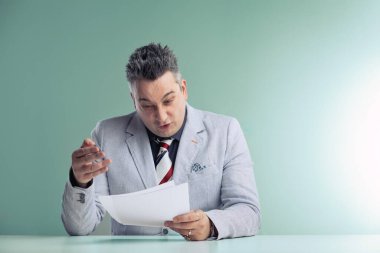 Middle-aged conspiracy theorist anchorman scrutinizes papers, his expression showing deep concern and disbelief clipart