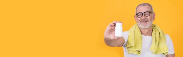 stock image man showing jar of vitamins or supplements