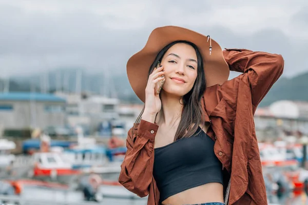 stock image happy tourist woman on vacation using phone at marina