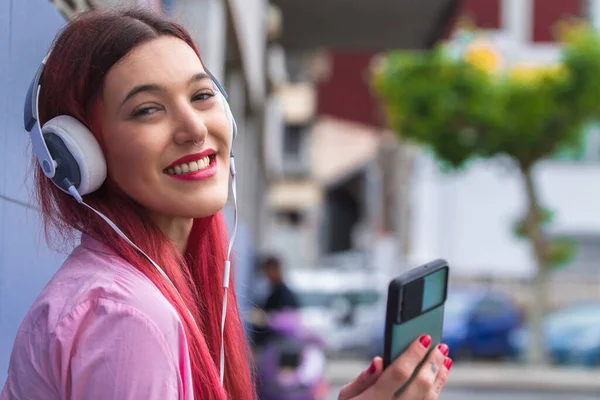 Souriant Rousse Jeune Femme Avec Écouteurs Téléphone Dans Rue — Photo